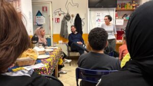Local residents engaged in discussion during an informal meeting for the SpoonTO: Food Lab Cittadino project in Turin.